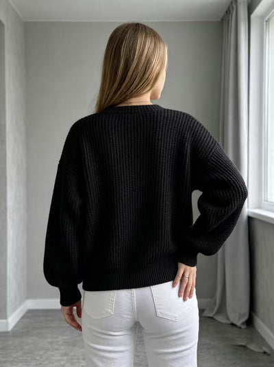 Black open-front knit cardigan with balloon sleeves, back view