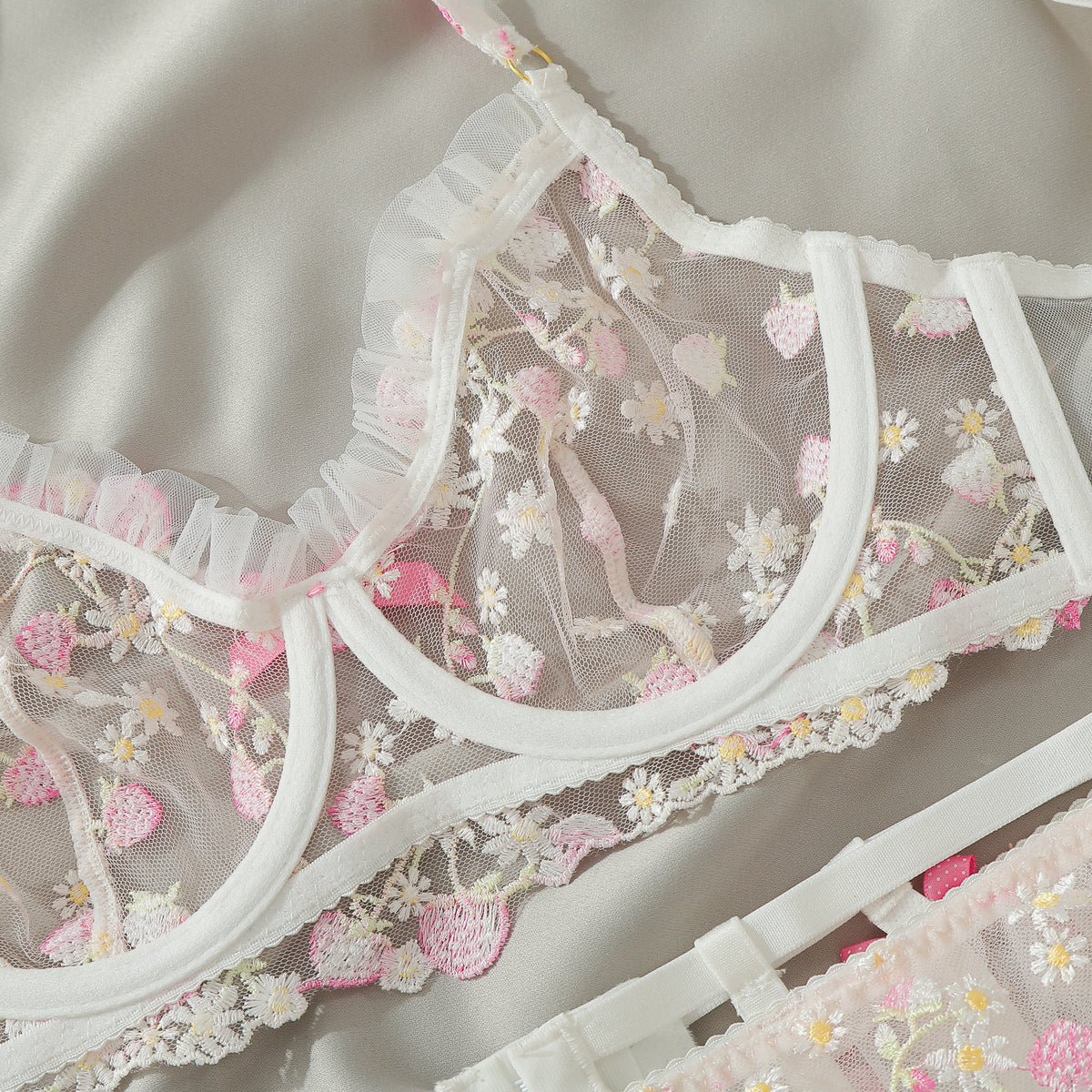 Floral embroidered mesh bra with white ruffle trim and scalloped lace edging, bow accents