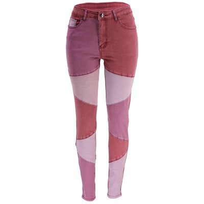 High-waist patchwork jeans with angled panel seams and slim leg, maroon with light pink panels.
