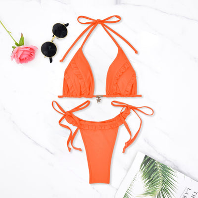 Orange triangle bikini set with ruffled trim and tie closures, flat lay