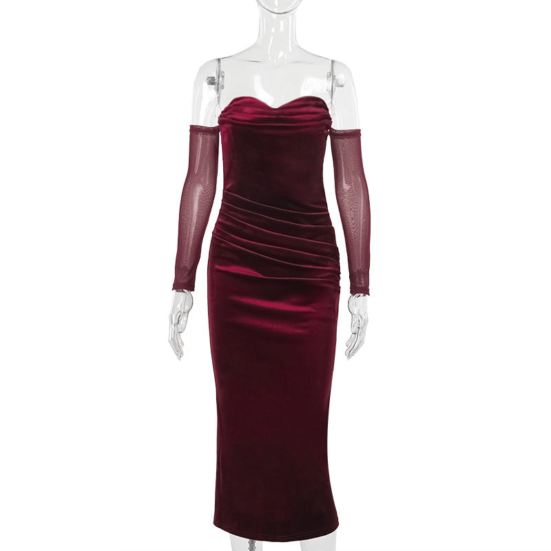 Burgundy one-shoulder suede pleated dress with long sheer sleeves and a mid-length straight skirt.