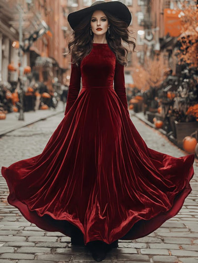 Burgundy velvet maxi dress with long sleeves and flared skirt