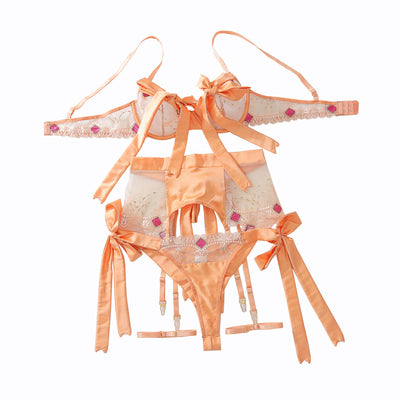 Embroidered mesh lingerie set in champagne with sheer panels, ribbon bows, garter straps
