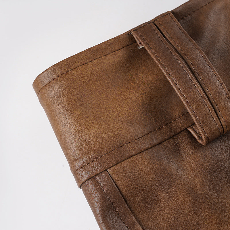 Waistband with stitched panel and belt loops on brown leather-look shorts.