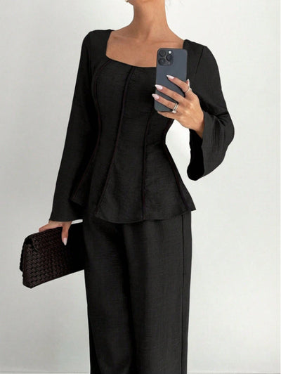 Black wide-leg pants set with shaped top, flared sleeves, and wide full-length pants