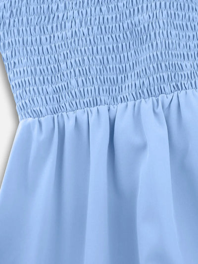 Close-up of light blue smocked waist with tiered skirt ruffles