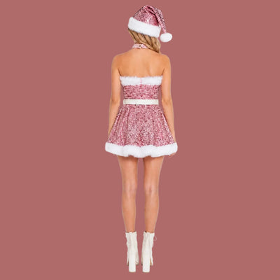 A woman shown from the back wearing a pink sequined strapless mini dress with white faux-fur trim, a matching pink and white Santa hat, and white ankle boots against a plain white background.