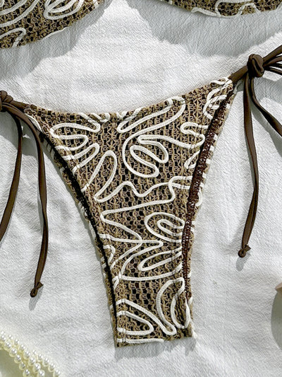 Side-tie bikini bottom with dark brown and white swirl lace pattern