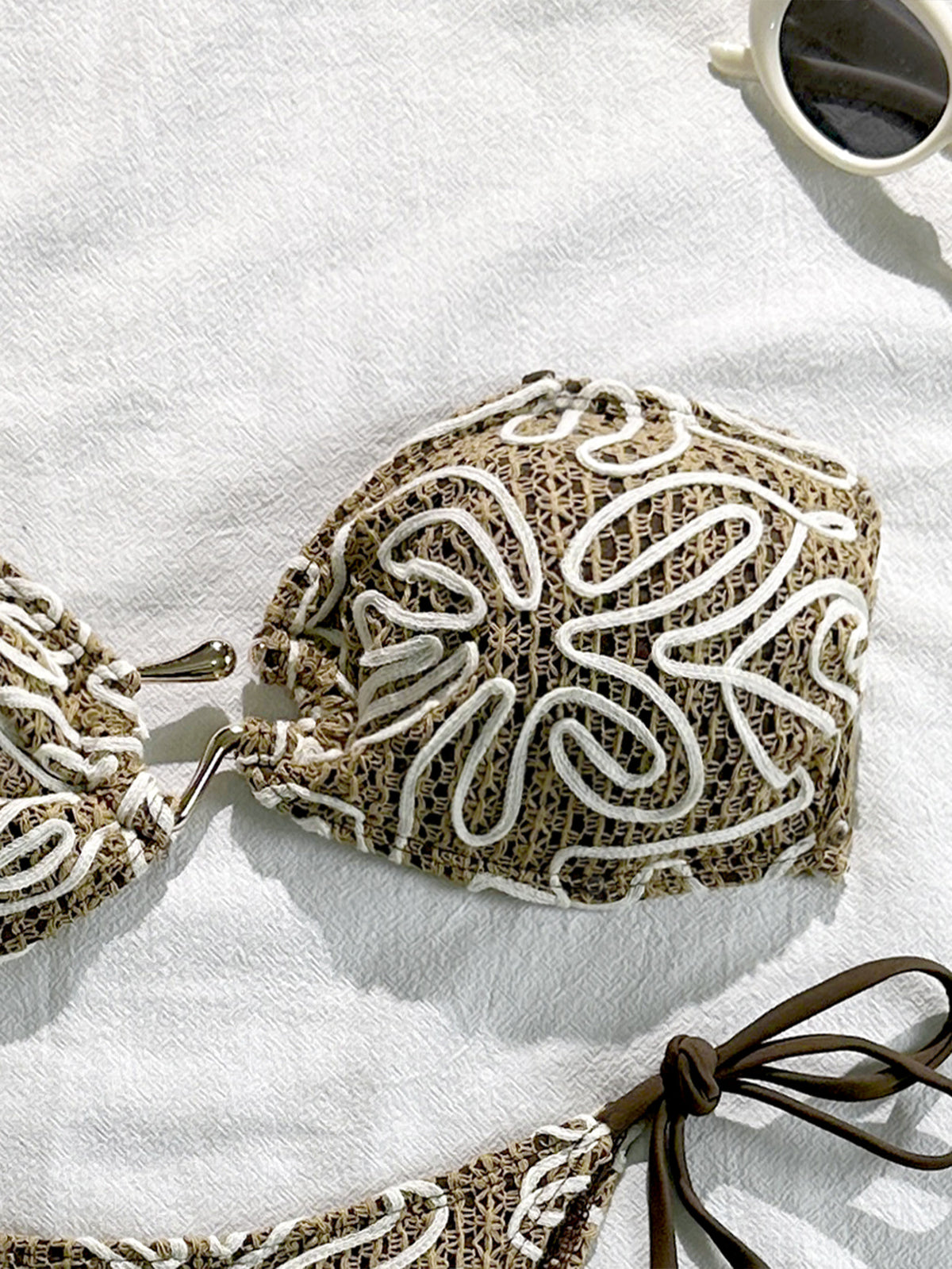 Halter bikini top with dark brown and white swirl embroidery and tie straps