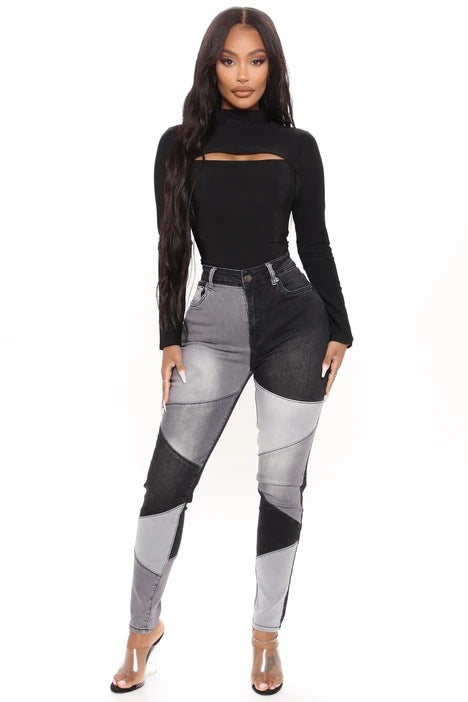 High-waist patchwork slim jeans in black with gray and white angled panels and contrast stitching.
