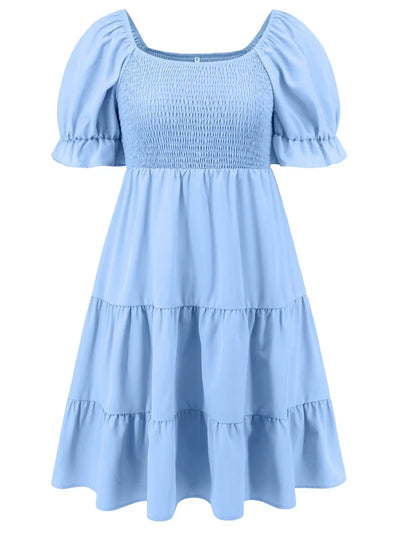 Light blue smocked bodice tiered mini dress with puff sleeves and flared skirt tiers