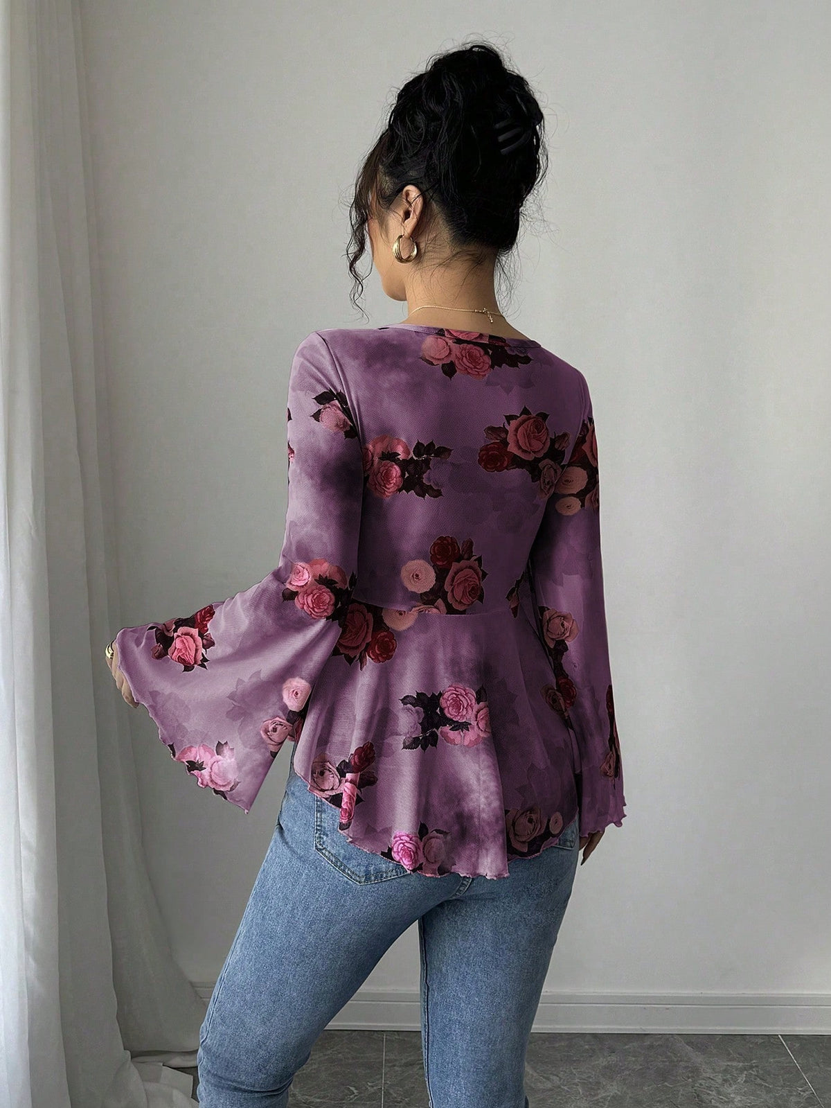 Purple floral bow-front blouse with long flared bell sleeves, back view