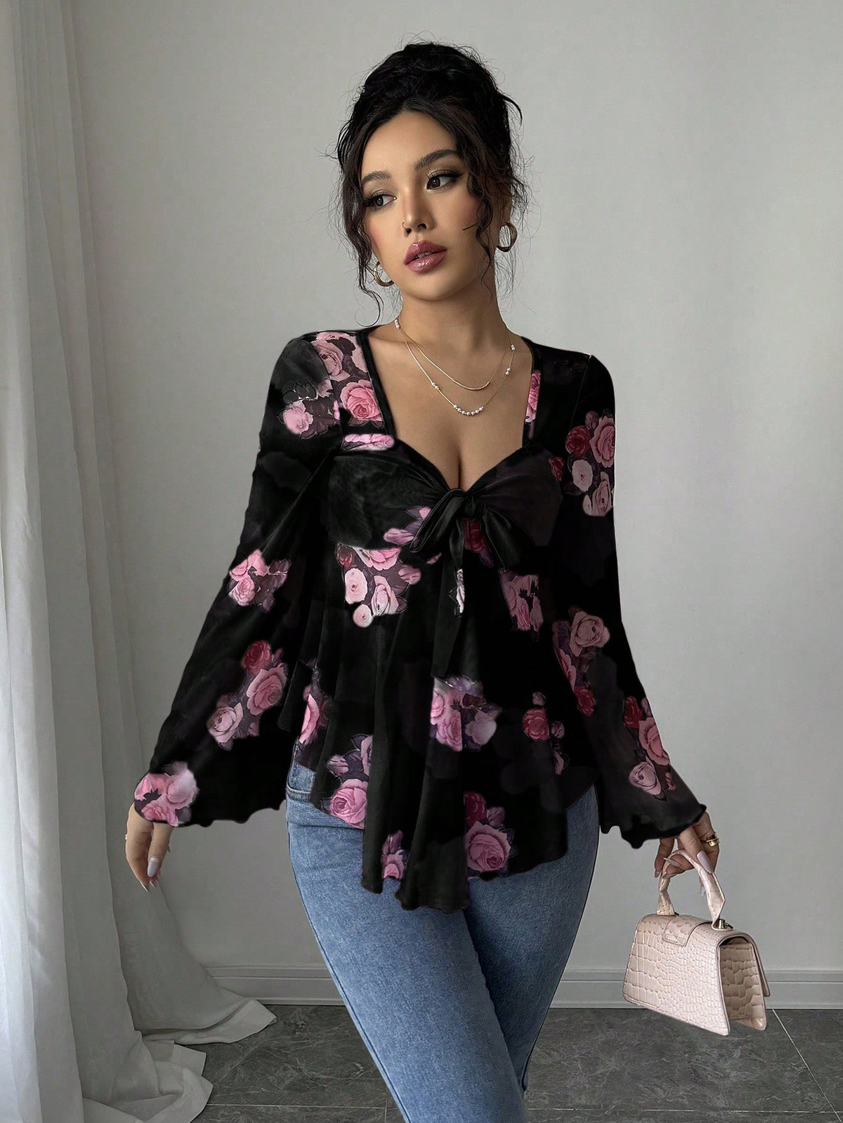 Black floral bow-front blouse with bow tie neckline and long flared bell sleeves
