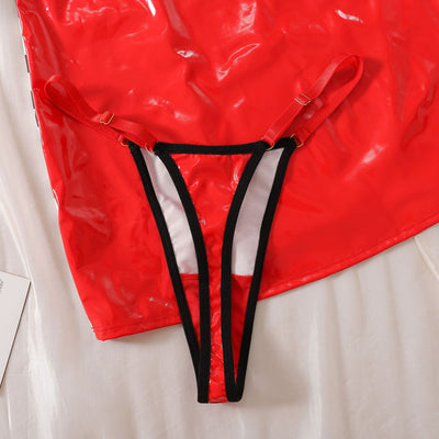 Glossy red thong-style lingerie with black vertical straps and bow-tie suspenders