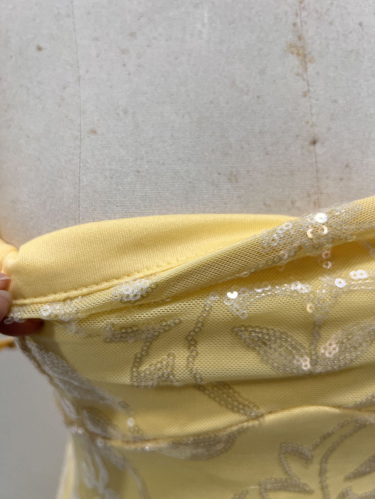 Yellow sequin mini dress close-up of fabric and sequined trim