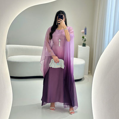 Ombre satin maxi dress with sheer flowing batwing sleeves in purple, draped overlay.