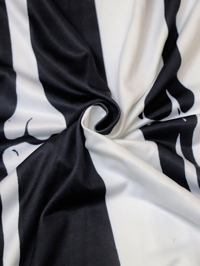 Black and white printed fabric with twisted skeleton-themed design