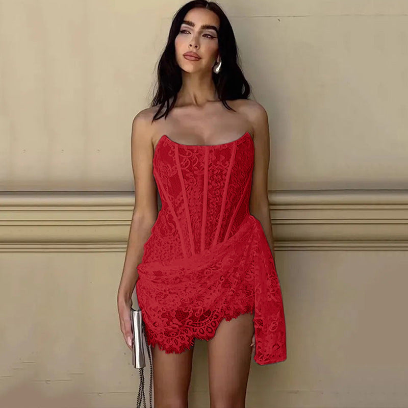 Woman wearing a red lace dress against a beige wall