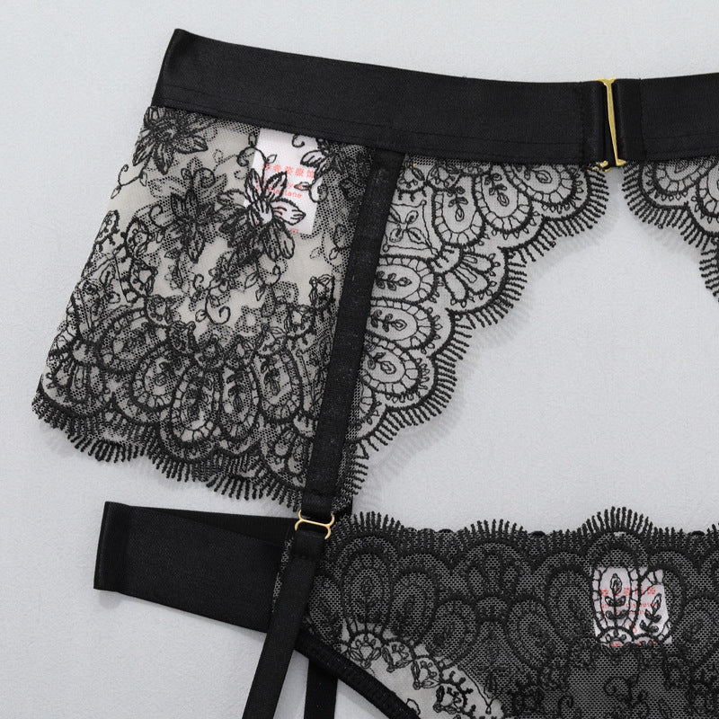 Black lace thong with scalloped lace panel and central buckle strap detail