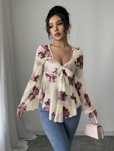 Cream floral bow-front blouse with bow tie neckline and long flared bell sleeves