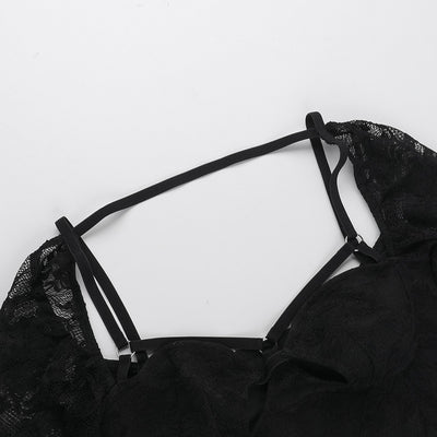 Black bodysuit neckline with triple strappy straps and lace shoulder panels.