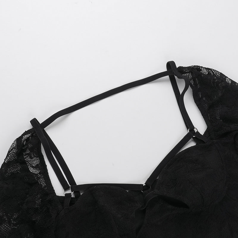 Black bodysuit neckline with triple strappy straps and lace shoulder panels.