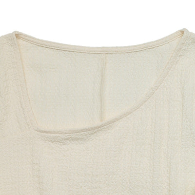 Cream knit dress neckline with soft scoop back and textured fabric