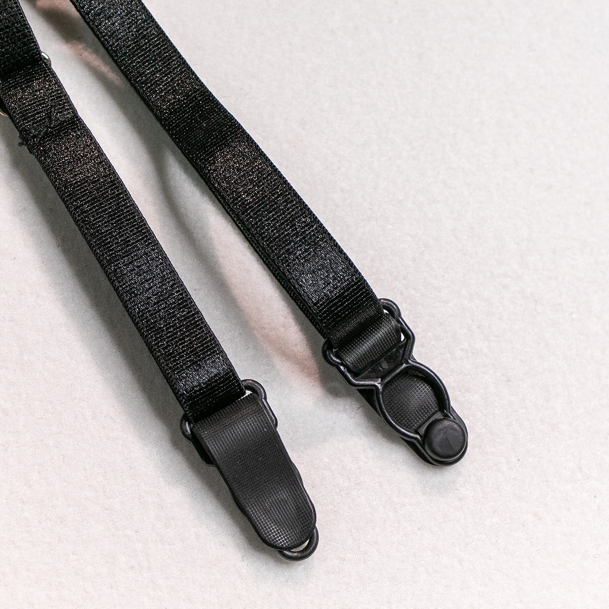 Black adjustable garter straps with metal clips