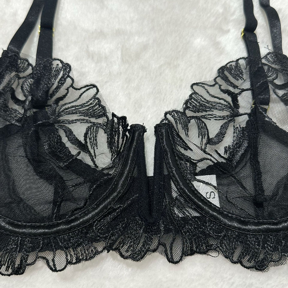 Black sheer floral lace bra set with underwire cups and scalloped lace neckline.
