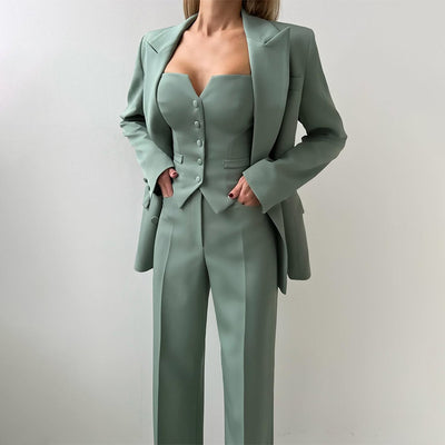 Three-piece suit set in muted green with button-front vest and wide-leg pants, blazer on