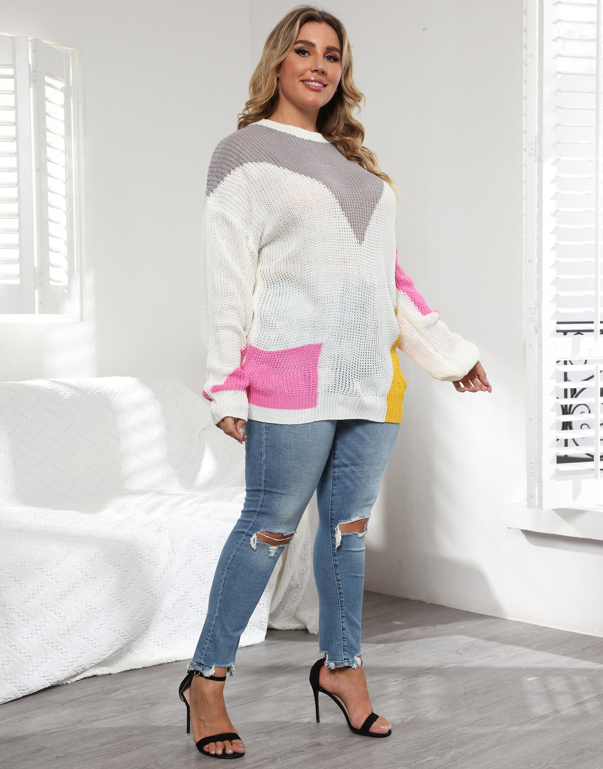 White knit crewneck sweater with color blocks: gray top, pink sleeve, yellow side panel