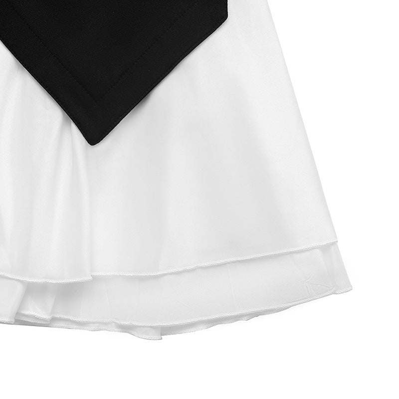 White ruffle layers and gathered hem seam on a black and white mini dress