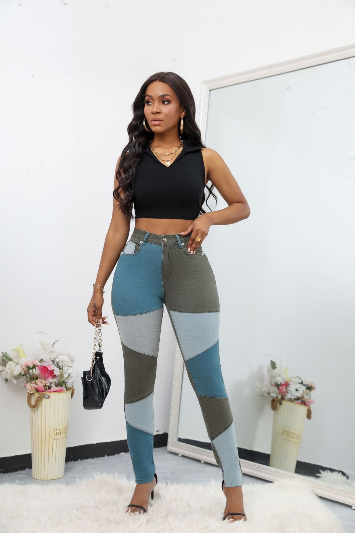 High-waist patchwork jeans with angled panel seams and slim leg, gray-green with teal and light blue panels.