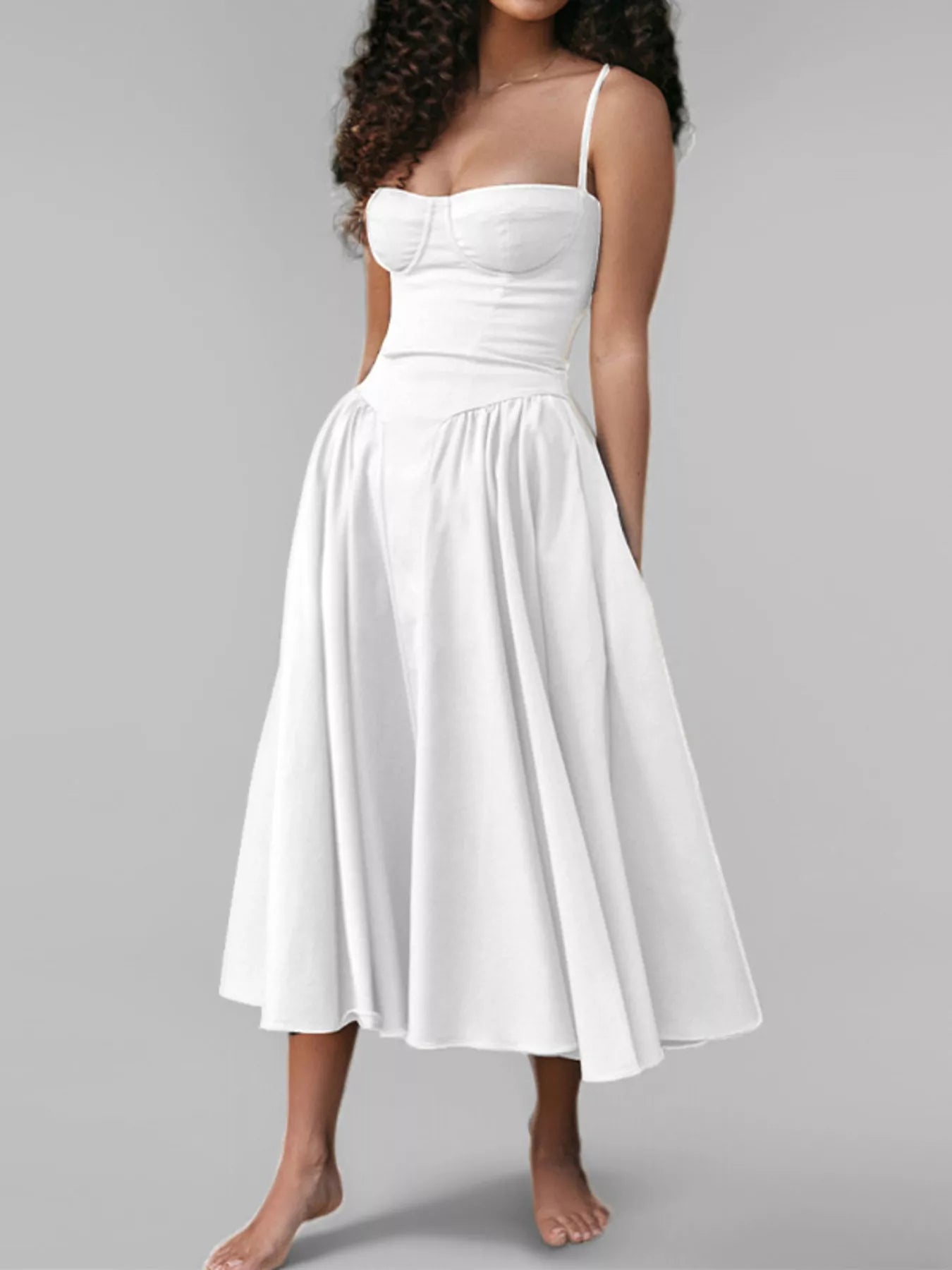White dress worn by a model on a gray background