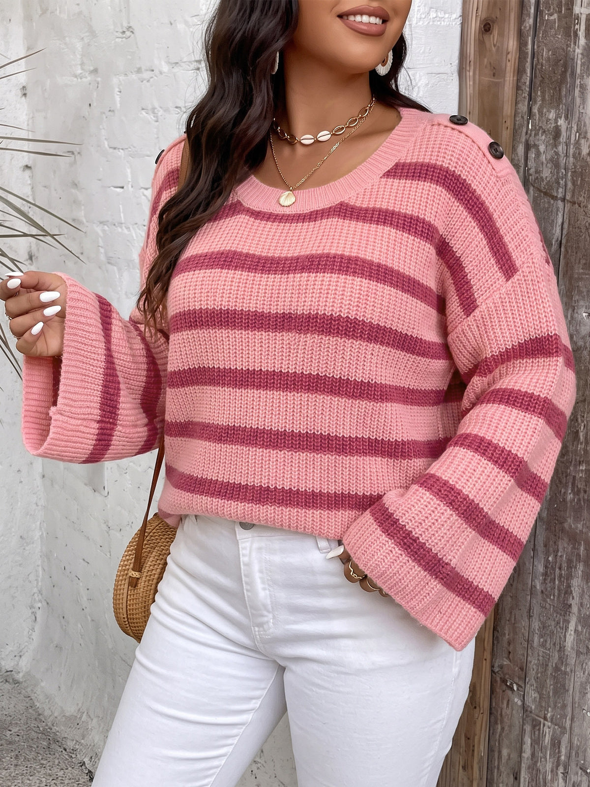 Pink striped knit pullover sweater with wide bell sleeves and ribbed crew neckline