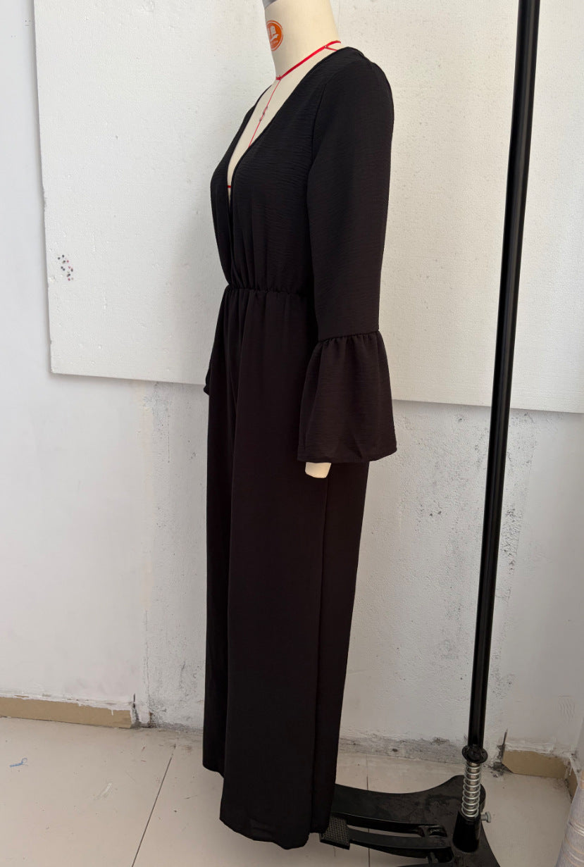 Black V-neck wide-leg jumpsuit with gathered waist and flared bell sleeves, side view