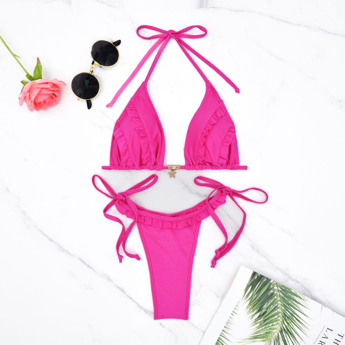 Watermelon red triangle bikini set with ruffled trim and tie closures, flat lay