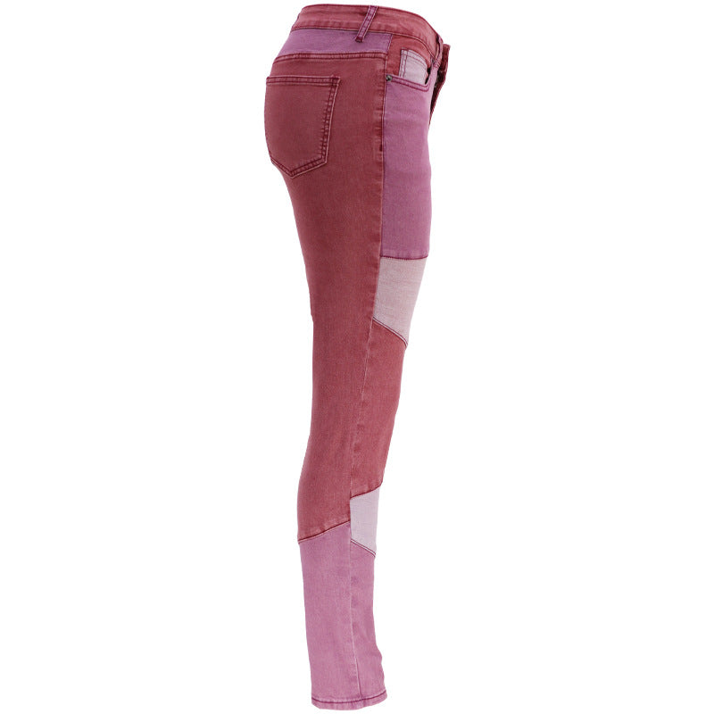 High-waist patchwork jeans with angled panel seams and slim leg, in maroon and light pink.