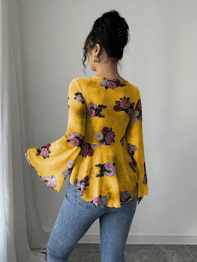 Yellow floral blouse with bow front, bell sleeves, flared hem; back view