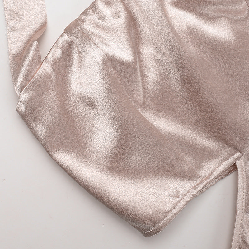 Champagne satin halter dress neckline and sleeve area close-up