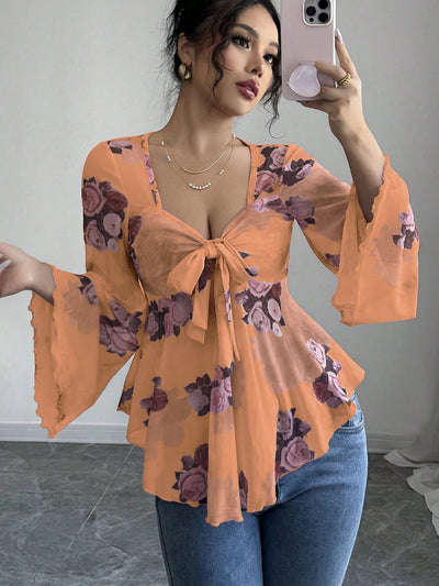 Floral bow-front blouse in apricot with long bell sleeves and flared hem