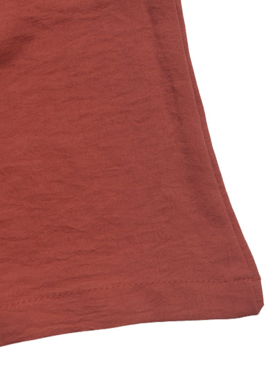 Rust-red fabric hem with stitched edge