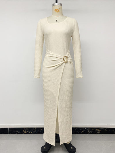 Cream knit maxi dress on mannequin with long sleeves, gathered hip and metal accent ring