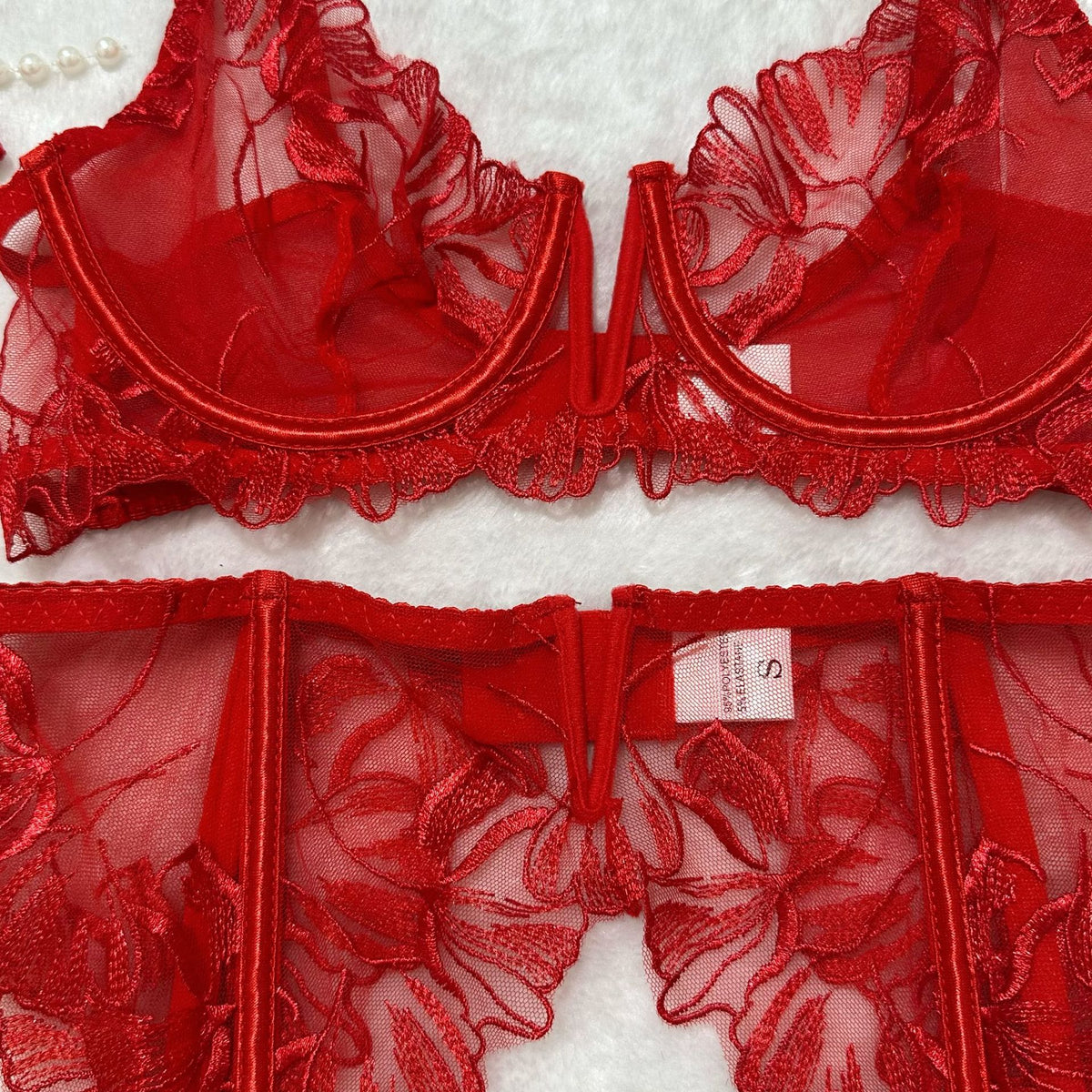 Red sheer floral lace bra set, underwire cups with lace overlay and central clasp.