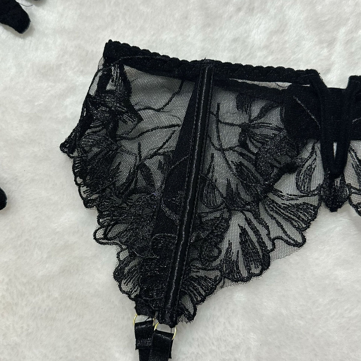 Black sheer floral lace lingerie garter belt, scalloped trim and lace panels.