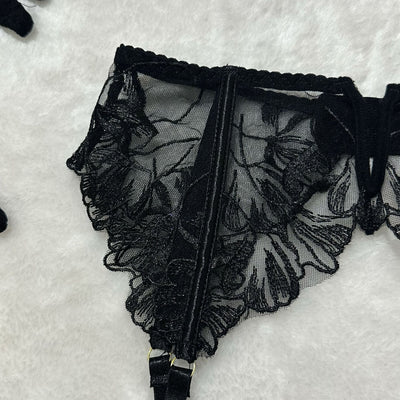 Black sheer floral lace lingerie garter belt, scalloped trim and lace panels.
