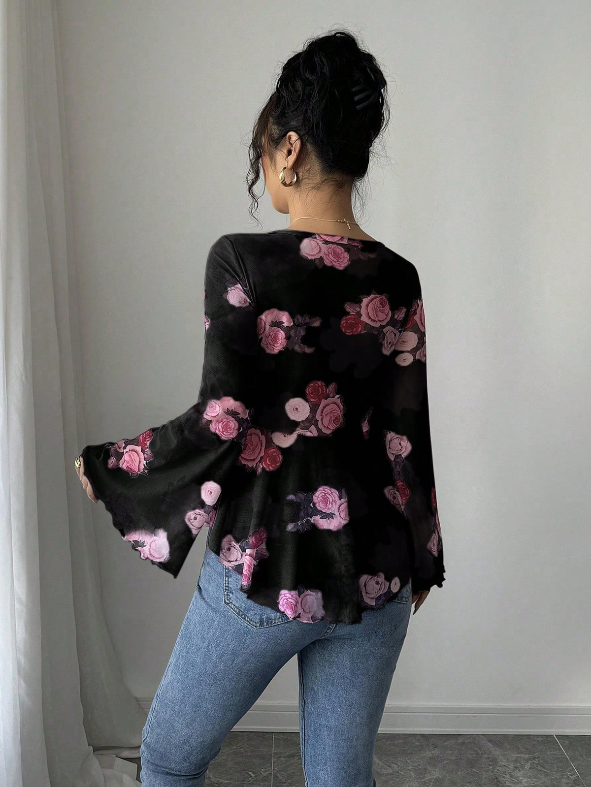 Black floral bow-front blouse with long flared bell sleeves