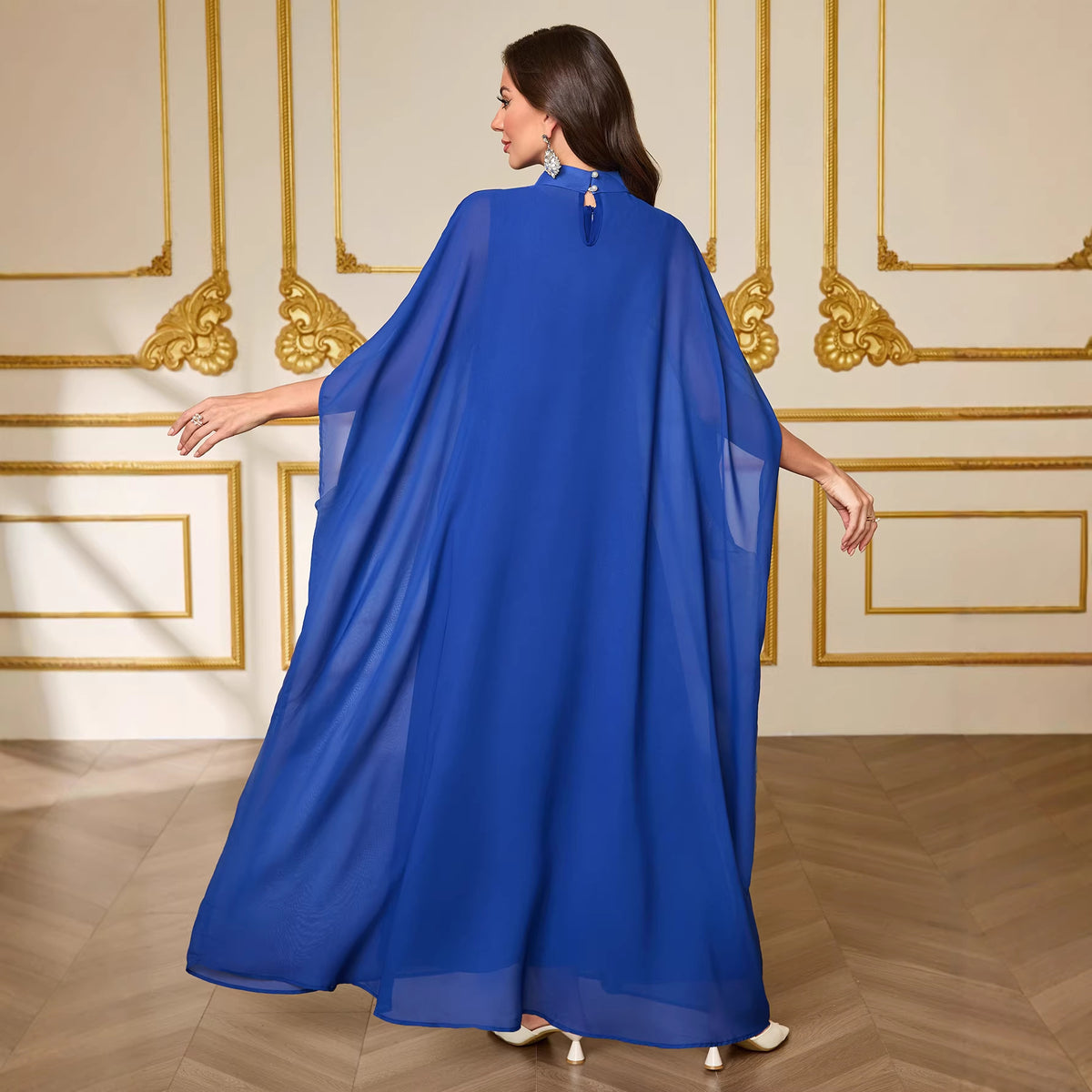 Two-piece gown dress back view in gemstone blue with high neckline and cape sleeves