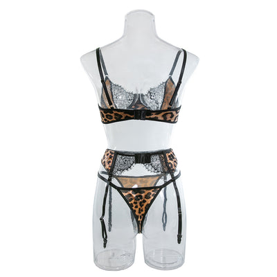 Leopard-print lace bra and garter belt set on mannequin, black lace trim and tie straps