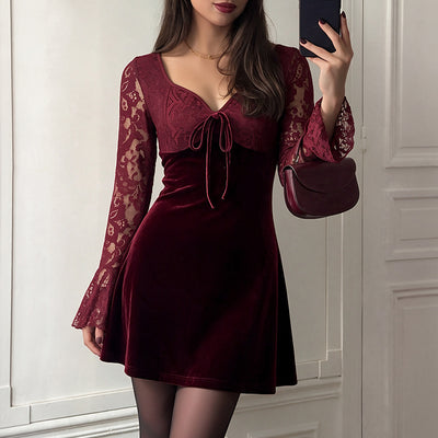 Burgundy velvet mini dress with lace sleeves and tied neckline bow, side view